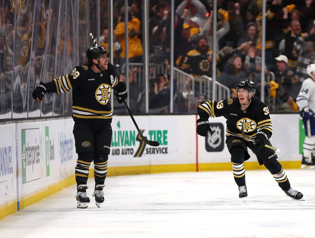 BOSTON, MASSACHUSETTS - MAY 04: David Pastrnak #88 of the Boston Bruins celebrates with his teammate Morgan Geekie #39 after scoring the game winning goal against the Toronto Maple Leafs during overtime in Game Seven of the First Round of the 2024 Stanley Cup Playoffs at TD Garden on May 04, 2024 in Boston, Massachusetts. (Photo by Maddie Meyer/Getty Images)