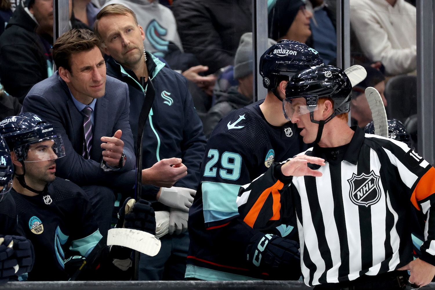 SEATTLE, WASHINGTON - NOVEMBER 16: Assistant coach Jay Leach of the Seattle Kraken talks with the official in overtime against the New York Islanders at Climate Pledge Arena on November 16, 2023 in Seattle, Washington. (Photo by Steph Chambers/Getty Images)