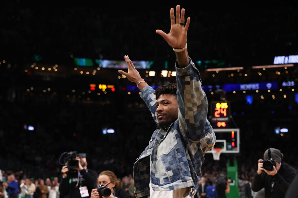 BOSTON, MASSACHUSETTS - FEBRUARY 04: Marcus Smart #36 of the Memphis Grizzlies waves to the crowd as he is honored during a game against the Boston Celtics at TD Garden on February 04, 2024 in Boston, Massachusetts. (Photo by Paul Rutherford/Getty Images)