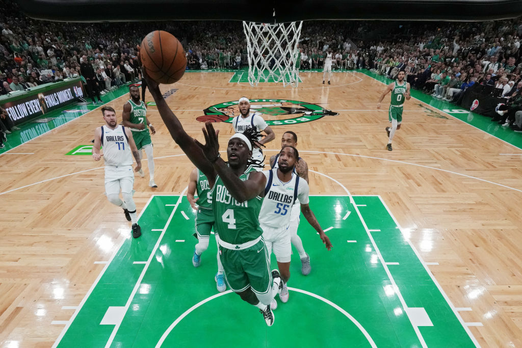 BOSTON, MASSACHUSETTS - JUNE 17: Jrue Holiday #4 of the Boston Celtics goes up for a basket past Derrick Jones Jr. #55 of the Dallas Mavericks during the first quarter of Game Five of the 2024 NBA Finals at TD Garden on June 17, 2024 in Boston, Massachusetts. NOTE TO USER: User expressly acknowledges and agrees that, by downloading and or using this photograph, User is consenting to the terms and conditions of the Getty Images License Agreement. (Photo by Pool/Getty Images)