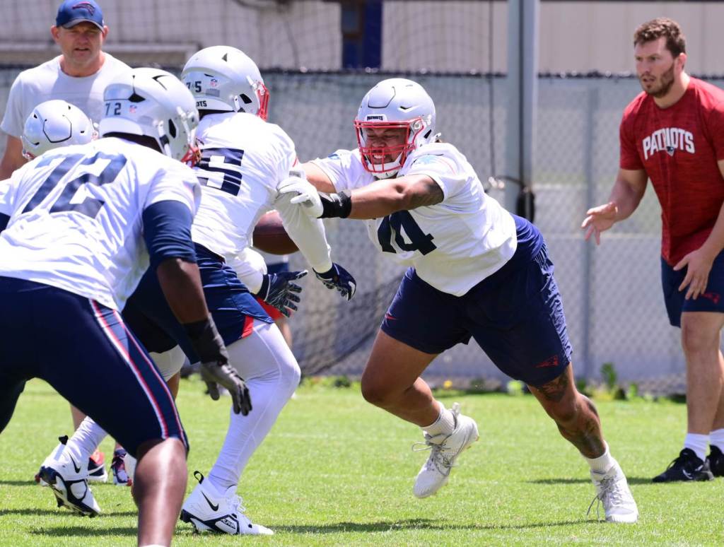 Jun 10, 2024; Foxborough, MA, USA; New England Patriots guard Michael Jordan (74) works with guard Ryan Johnson (75) at minicamp at Gillette Stadium. Credit: Eric Canha-USA TODAY Sports