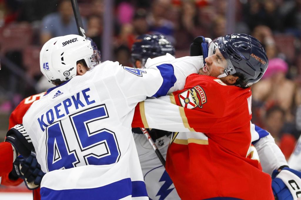 Oct 21, 2022; Sunrise, Florida, USA; Tampa Bay Lightning left wing Cole Koepke (45) and Florida Panthers center Colin White (6) push each other during the third period at FLA Live Arena. Mandatory Credit: Sam Navarro-USA TODAY Sports