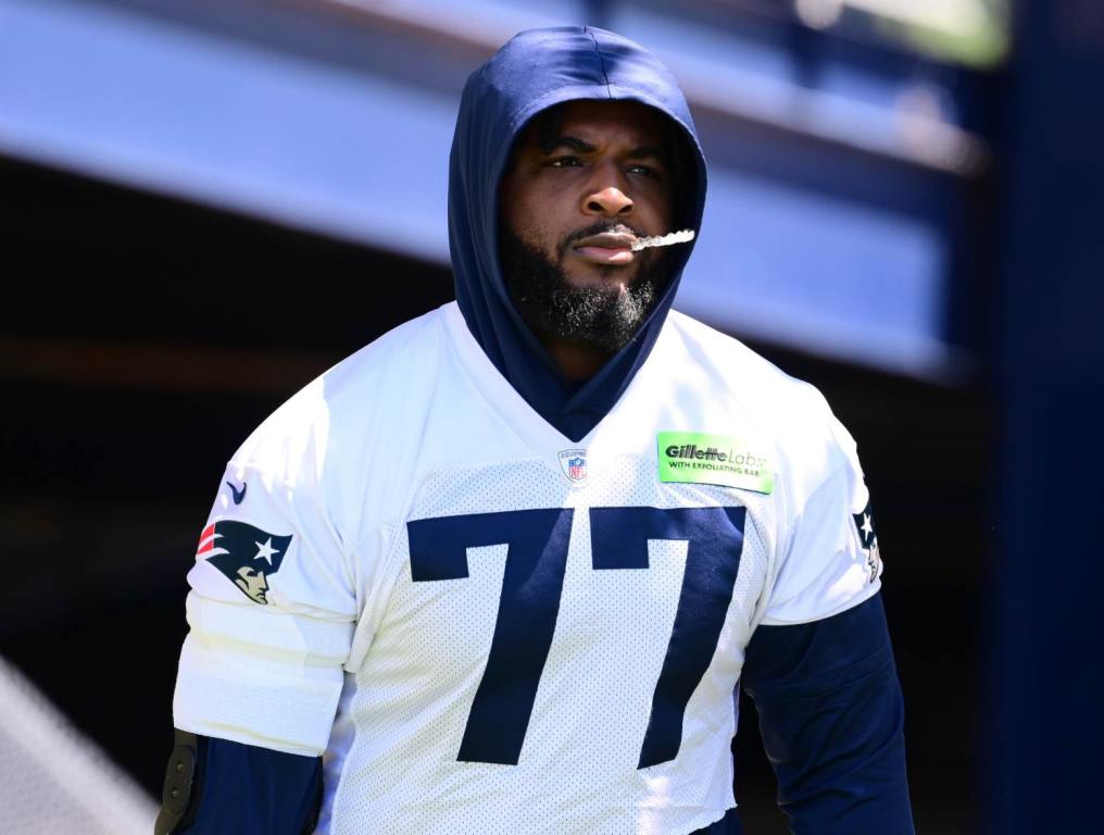 Jun 10, 2024; Foxborough, MA, USA; New England Patriots offensive tackle Chukwuma Okorafor (77) walks to the practice fields for minicamp at Gillette Stadium. Credit: Eric Canha-USA TODAY Sports