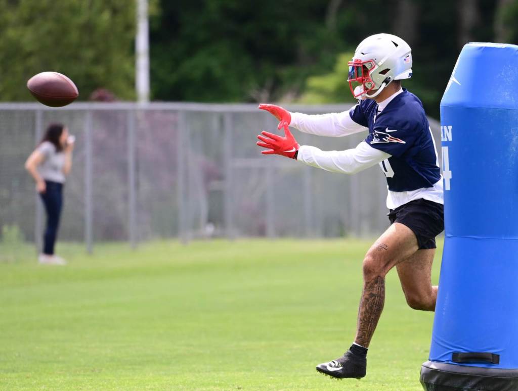 Jun 12, 2024; Foxborough, MA, USA; New England Patriots cornerback Christian Gonzalez (0) makes a catch at minicamp at Gillette Stadium. Credit: Eric Canha-USA TODAY Sports