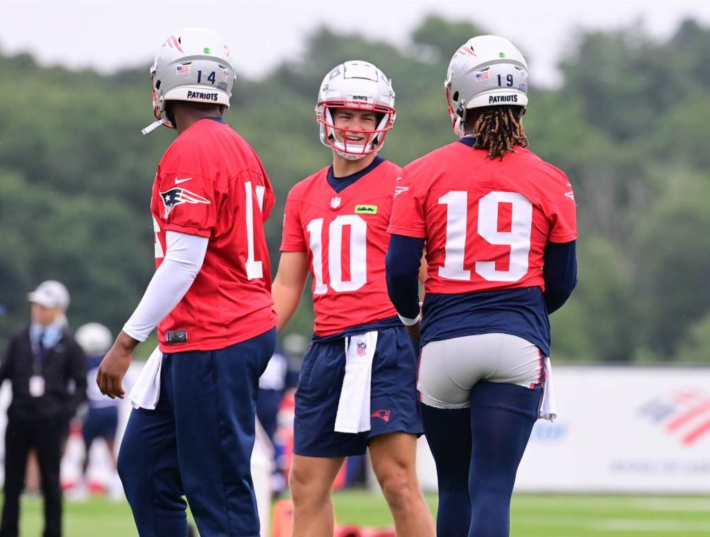 Jul 24, 2024; Foxborough, MA, USA; New England Patriots quarterback Drake Maye (10) waits for drills to start with quarterback Jacoby Brissett (14) and quarterback Joe Milton III (19) at Patriots training camp at Gillette Stadium. Credit: Eric Canha-USA TODAY Sports