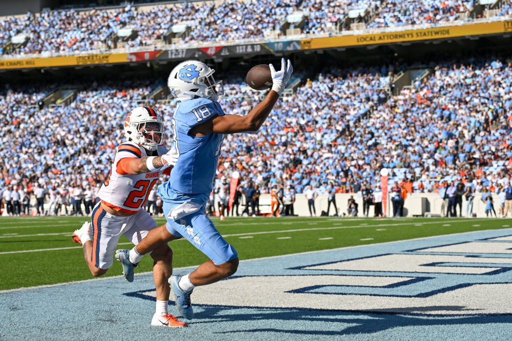 CHAPEL HILL, NORTH CAROLINA - OCTOBER 07: Bryson Nesbit #18 of the North Carolina Tar Heels makes a touchdown catch against Myles Farmer #20 of the Syracuse Orange during the first half of their game at Kenan Memorial Stadium on October 07, 2023 in Chapel Hill, North Carolina. (Photo by Grant Halverson/Getty Images)