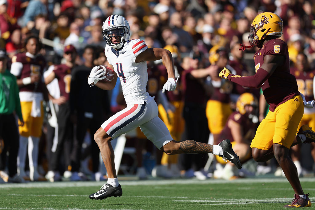 TEMPE, ARIZONA - NOVEMBER 25: Wide receiver Tetairoa McMillan #4 of the Arizona Wildcats runs with the football after a reception past defensive back Chris Edmonds #5 of the Arizona State Sun Devils during the first half of the NCAAF game at Mountain America Stadium on November 25, 2023 in Tempe, Arizona. (Photo by Christian Petersen/Getty Images)