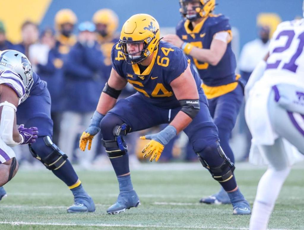 Nov 19, 2022; Morgantown, West Virginia, USA; West Virginia Mountaineers offensive lineman Wyatt Milum (64) during a play during the third quarter against the Kansas State Wildcats at Mountaineer Field at Milan Puskar Stadium. Credit: Ben Queen-USA TODAY Sports