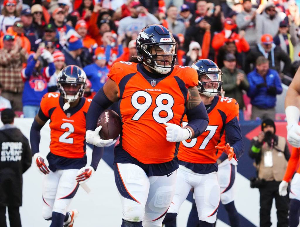 Nov 26, 2023; Denver, Colorado, USA; Denver Broncos defensive tackle Mike Purcell (98) following a defensive stop in the first quarter against the Cleveland Browns at Empower Field at Mile High. Credit: Ron Chenoy-USA TODAY Sports