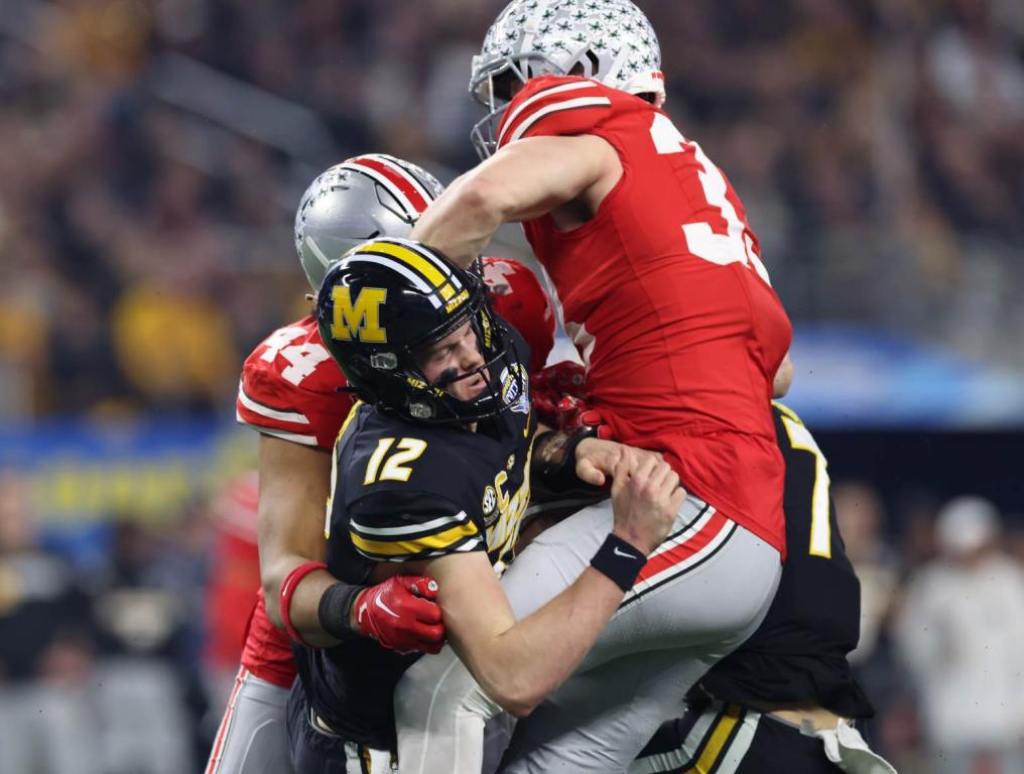 Dec 29, 2023; Arlington, TX, USA; Missouri Tigers quarterback Brady Cook (12) is sacked by Ohio State Buckeyes defensive end JT Tuimoloau (44) and defensive end Jack Sawyer (33) in the first quarter at AT&T Stadium. Credit: Tim Heitman-USA TODAY Sports