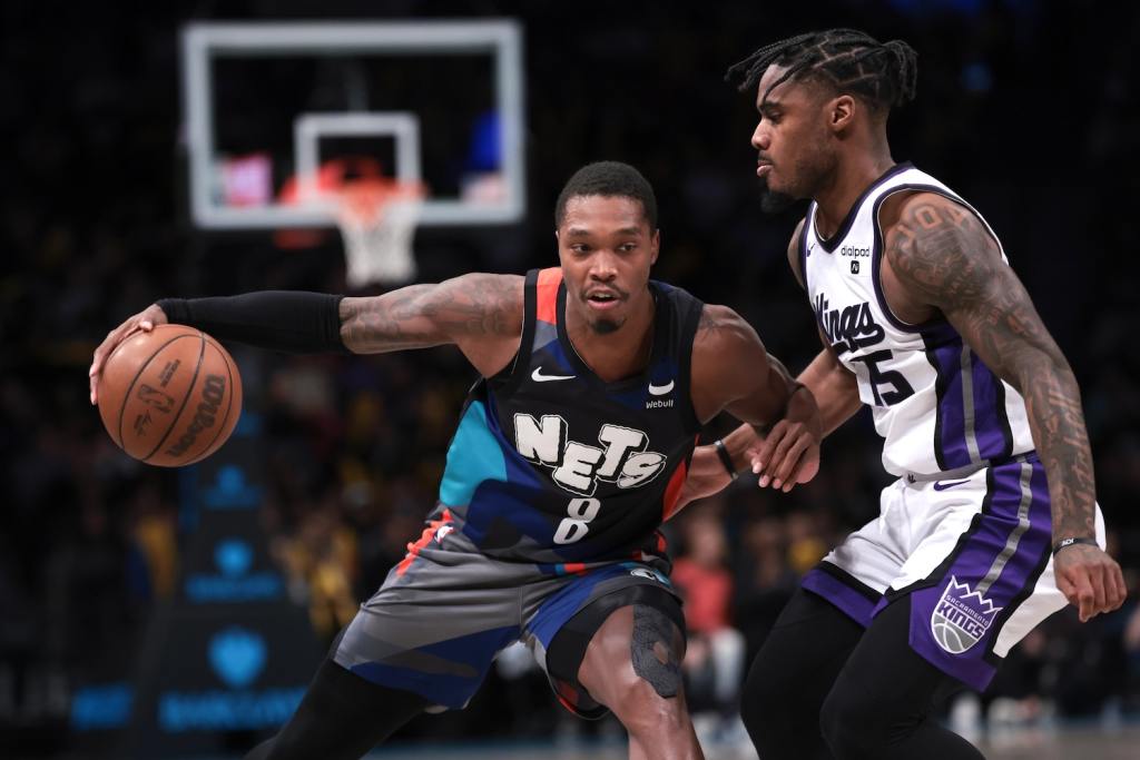 Apr 7, 2024; Brooklyn, New York, USA; Brooklyn Nets guard Lonnie Walker IV (8) dribbles against Sacramento Kings guard Davion Mitchell (15) during the second half at Barclays Center. Mandatory Credit: Vincent Carchietta-USA TODAY Sports