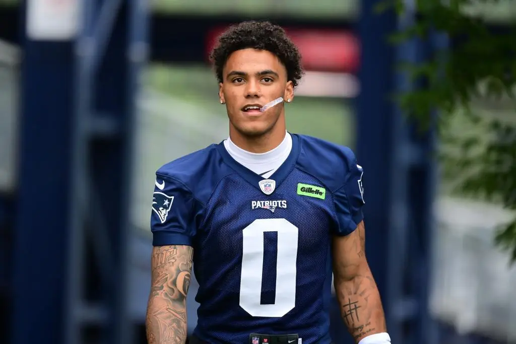 Jul 24, 2024; Foxborough, MA, USA; New England Patriots cornerback Christian Gonzalez (0) walks to the practice field during training camp at Gillette Stadium. Mandatory Credit: Eric Canha-USA TODAY Sports