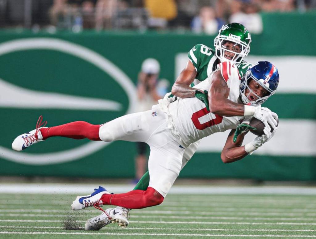 Aug 24, 2024; East Rutherford, New Jersey, USA; New York Jets defensive back Nehemiah Shelton (38) breaks up a pass intend for New York Giants wide receiver John Jiles (0) during the second half at MetLife Stadium. Credit: Vincent Carchietta-USA TODAY Sports