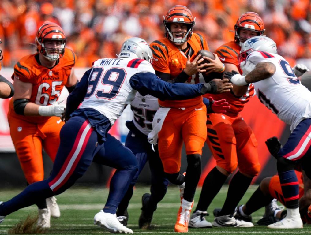 Cincinnati Bengals quarterback Joe Burrow (9) is sacked by Keion White in the fourth quarter of the NFL Week 1 game between the Cincinnati Bengals and the New England Patriots at Paycor Stadium in downtown Cincinnati on Sunday, Sept. 8, 2024. The Patriots won the season opener, 16-10. (Sam Greene/The Enquirer/USA Today Network)