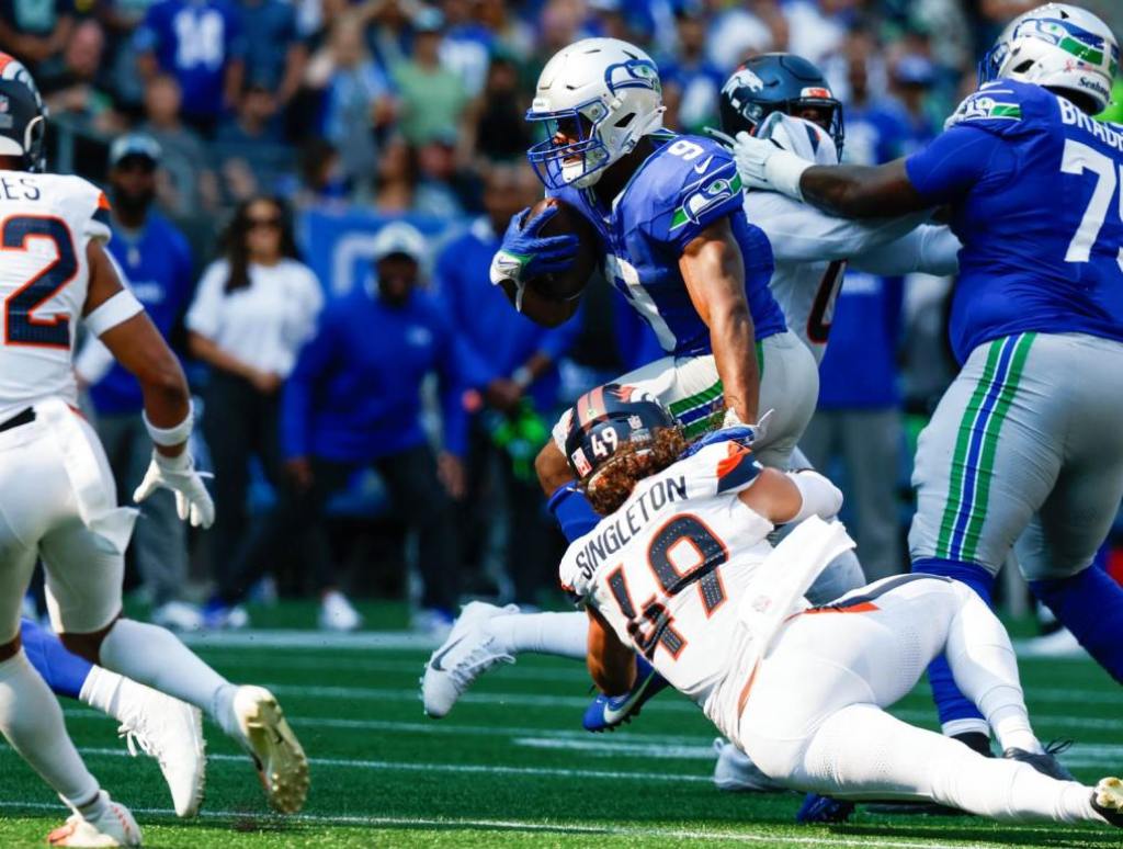 Sep 8, 2024; Seattle, Washington, USA; Seattle Seahawks running back Kenneth Walker III (9) breaks a tackle attempt by Denver Broncos linebacker Alex Singleton (49) to rush for a touchdown during the third quarter at Lumen Field. Credit: Joe Nicholson-Imagn Images