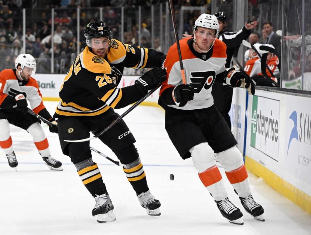 Oct 1, 2024; Boston, Massachusetts, USA; Boston Bruins center Elias Lindholm (28) defends Philadelphia Flyers defenseman Nick Seeler (24) during the second period at the TD Garden. Mandatory Credit: Brian Fluharty-Imagn Images