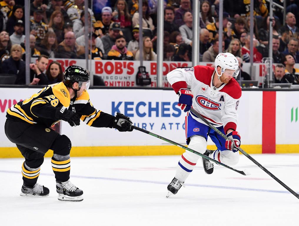 Oct 10, 2024; Boston, Massachusetts, USA; Montreal Canadiens defenseman Mike Matheson (8) controls the puck in front of Boston Bruins center Elias Lindholm (28) during the second period at TD Garden. Mandatory Credit: Bob DeChiara-Imagn Images