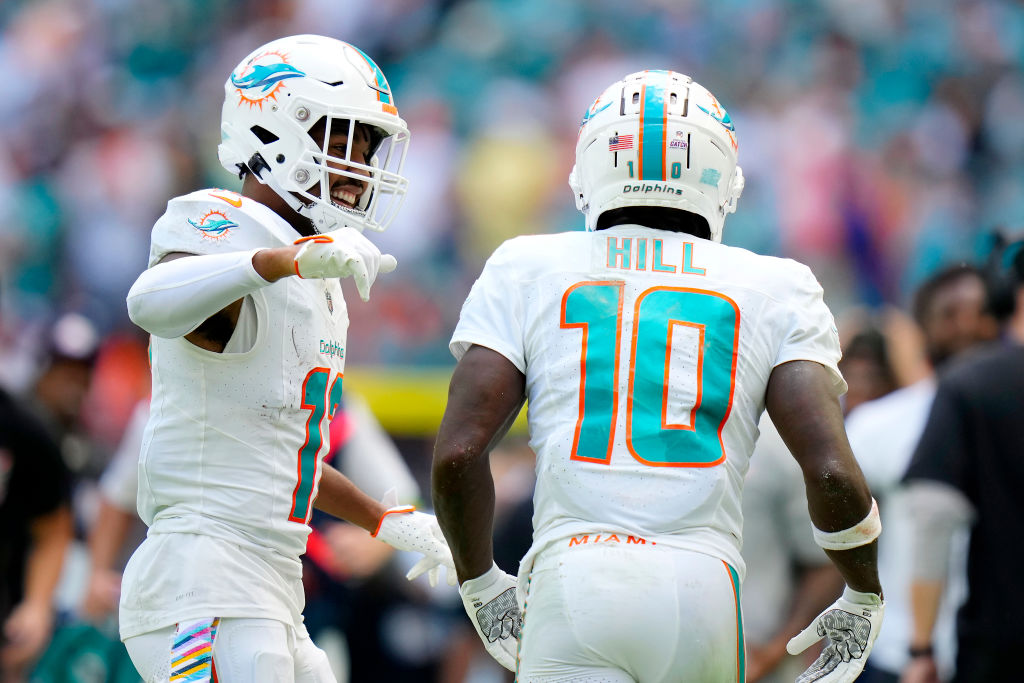 MIAMI GARDENS, FLORIDA - OCTOBER 08: Jaylen Waddle #17 celebrates with Tyreek Hill #10 of the Miami Dolphins after gaining yardage against the New York Giants during the second quarter at Hard Rock Stadium on October 08, 2023 in Miami Gardens, Florida. (Photo by Rich Storry/Getty Images)