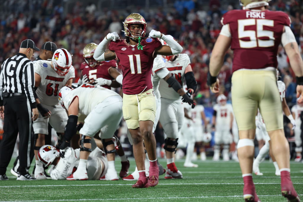 CHARLOTTE, NORTH CAROLINA - DECEMBER 2: Patrick Payton #11 of the Florida State Seminoles reacts after Braden Fiske #55 of the Florida State Seminoles sacks Jack Plummer #13 of the Louisville Cardinals during the second half during the ACC Championship at Bank of America Stadium on December 2, 2023 in Charlotte, North Carolina. (Photo by Isaiah Vazquez/Getty Images)