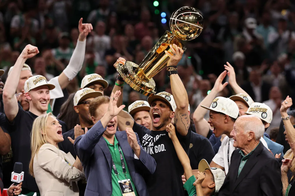 BOSTON, MASSACHUSETTS - JUNE 17: Head coach Joe Mazzulla of the Boston Celtics yells while lifting the Larry O’Brien Championship Trophy after Boston's 106-88 win against the Dallas Mavericks in Game Five of the 2024 NBA Finals at TD Garden on June 17, 2024 in Boston, Massachusetts. NOTE TO USER: User expressly acknowledges and agrees that, by downloading and or using this photograph, User is consenting to the terms and conditions of the Getty Images License Agreement. (Photo by Elsa/Getty Images)