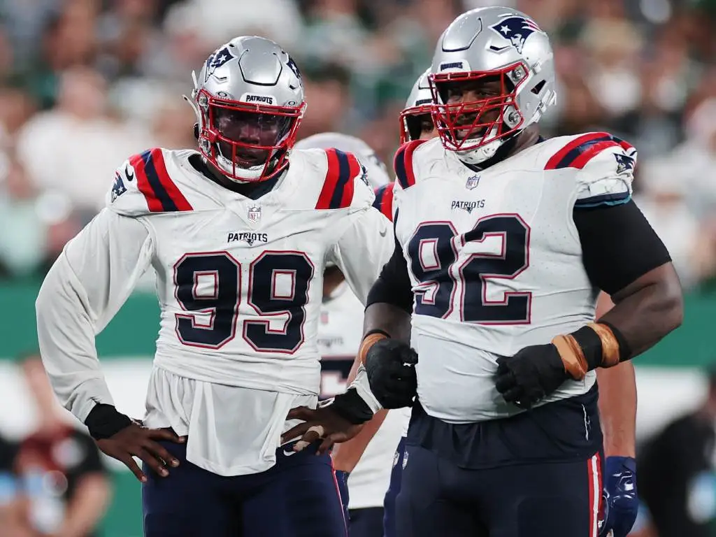 EAST RUTHERFORD, NEW JERSEY - SEPTEMBER 19: Keion White #99 and Davon Godchaux #92 of the New England Patriots look on during the game against the New York Jets at MetLife Stadium on September 19, 2024 in East Rutherford, New Jersey. (Photo by Sarah Stier/Getty Images)