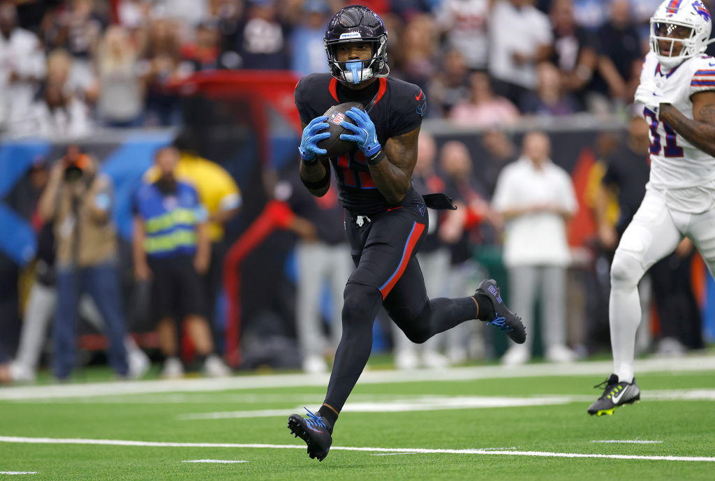 HOUSTON, TEXAS - OCTOBER 06: Nico Collins #12 of the Houston Texans catches a pass for a first quarter touchdown against the Buffalo Bills at NRG Stadium on October 06, 2024 in Houston, Texas. (Photo by Tim Warner/Getty Images)