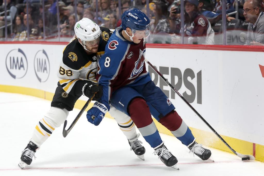 DENVER, COLORADO - OCTOBER 16: David Pastrnak #88 of the Boston Bruins fights for the puck against Cale Makar #8 of the Colorado Avalanche in the third period at Ball Arena on October 16, 2024 in Denver, Colorado. (Photo by Matthew Stockman/Getty Images)