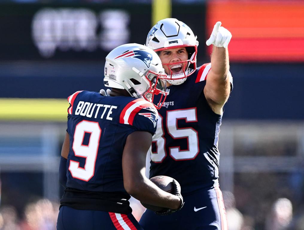 Oct 6, 2024; Foxborough, Massachusetts, USA; New England Patriots wide receiver Kayshon Boutte (9) celebrates with tight end Hunter Henry (85) after making a completion against the Miami Dolphins during the second half at Gillette Stadium. Mandatory Credit: Brian Fluharty-Imagn Images