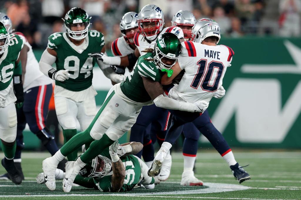 Sep 19, 2024; East Rutherford, New Jersey, USA; New York Jets linebacker Jamien Sherwood (44) tackles New England Patriots quarterback Drake Maye (10) during the fourth quarter at MetLife Stadium. Mandatory Credit: Brad Penner-Imagn Images