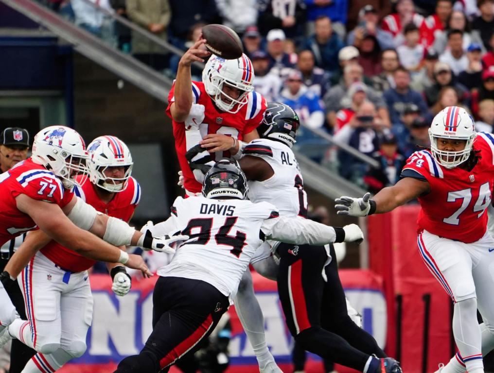 Oct 13, 2024; Foxborough, Massachusetts, USA; Houston Texans linebacker Azeez Al-Shaair (0) and Houston Texans defensive tackle Khalil Davis (94) pressure New England Patriots quarterback Drake Maye (10) as he makes a throw during the first half at Gillette Stadium. Credit: Gregory Fisher-Imagn Images