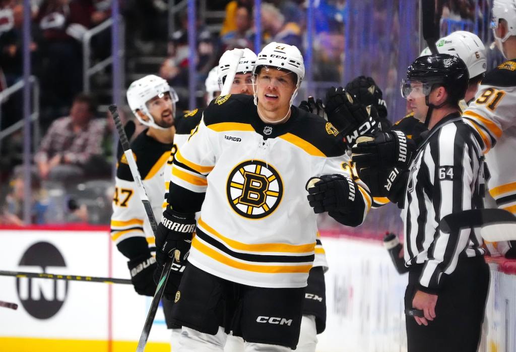 Oct 16, 2024; Denver, Colorado, USA; Boston Bruins defenseman Hampus Lindholm (27) celebrates his goal with teammates in the second period against the Colorado Avalanche at Ball Arena. Mandatory Credit: Ron Chenoy-Imagn Images