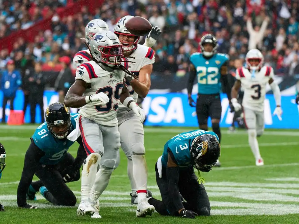 Oct 20, 2024; London, United Kingdom; New England Patriots running back JaMycal Hasty (39) reacts after a touchdown with New England Patriots tight end Hunter Henry (85) in the first half during an NFL International Series game at Wembley Stadium. Credit: Peter van den Berg-Imagn Images