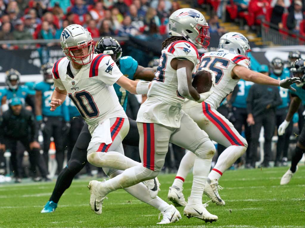 Oct 20, 2024; London, United Kingdom; New England Patriots quarterback Drake Maye (10) passes to New England Patriots running back Rhamondre Stevenson (38) in the first half during an NFL International Series game at Wembley Stadium. Photo Credit: Peter van den Berg-Imagn Images