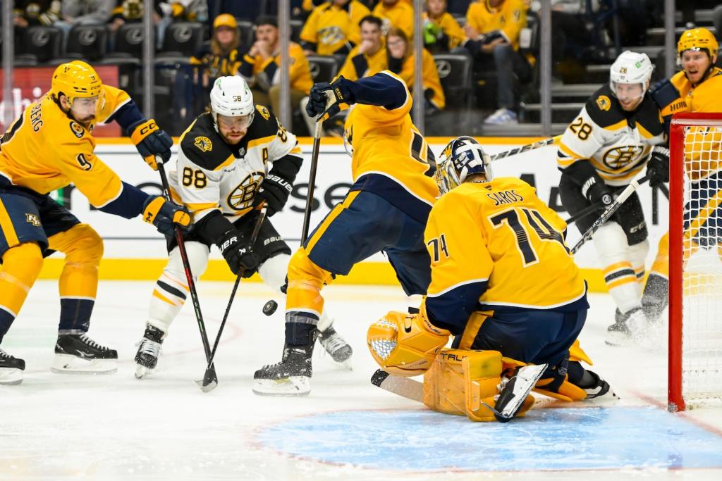 Oct 22, 2024; Nashville, Tennessee, USA; Nashville Predators goaltender Juuse Saros (74) blocks the shot of Boston Bruins right wing David Pastrnak (88) during the second period at Bridgestone Arena. Mandatory Credit: Steve Roberts-Imagn Images