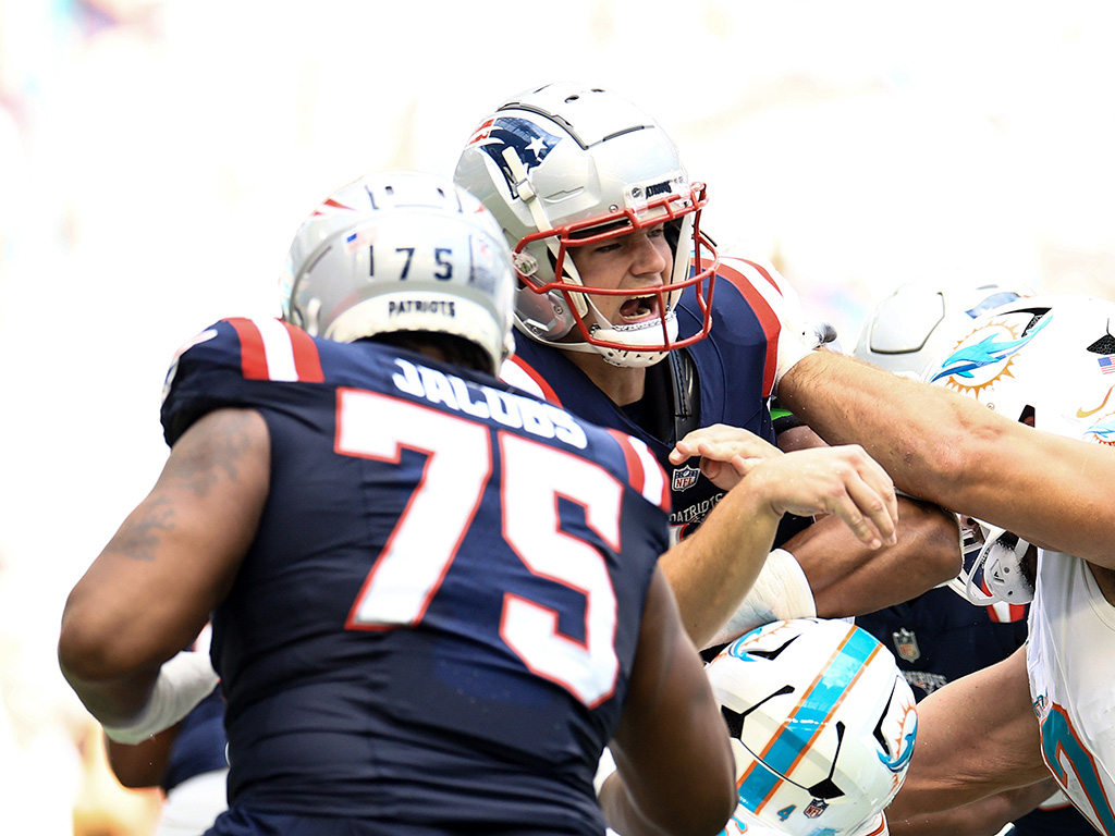 MIAMI GARDENS, FLORIDA - NOVEMBER 24: Drake Maye #10 of the New England Patriots under pressure against the Miami Dolphins during the second quarter at Hard Rock Stadium on November 24, 2024 in Miami Gardens, Florida. (Photo by Carmen Mandato/Getty Images)