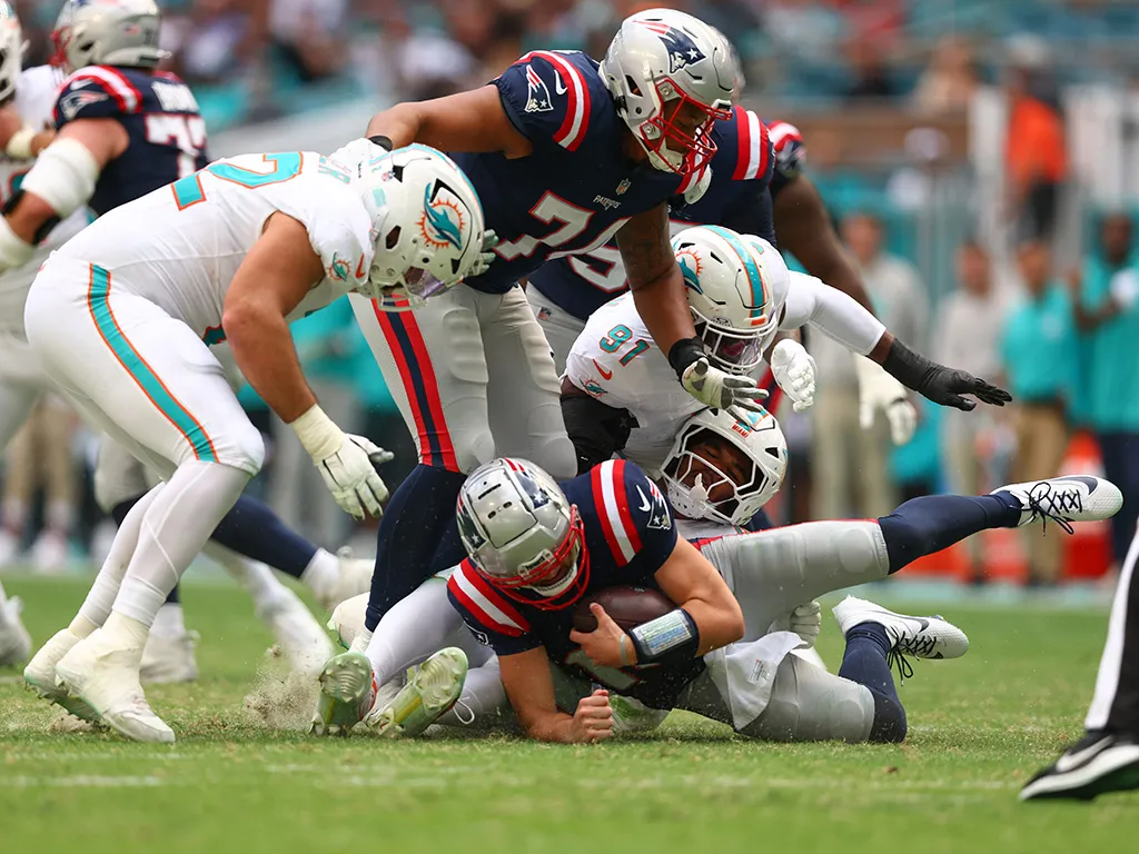 MIAMI GARDENS, FLORIDA - NOVEMBER 24: Chop Robinson #44 of the Miami Dolphins sacks Drake Maye #10 of the New England Patriots during the second quarter at Hard Rock Stadium on November 24, 2024 in Miami Gardens, Florida. (Photo by Megan Briggs/Getty Images)