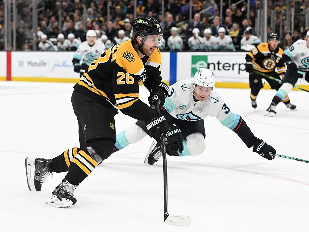 BOSTON, MASSACHUSETTS - NOVEMBER 03: Elias Lindholm #28 of the Boston Bruins skates against Will Borgen #3 of the Seattle Kraken during the first period at TD Garden on November 03, 2024 in Boston, Massachusetts. (Photo by Maddie Meyer/Getty Images)