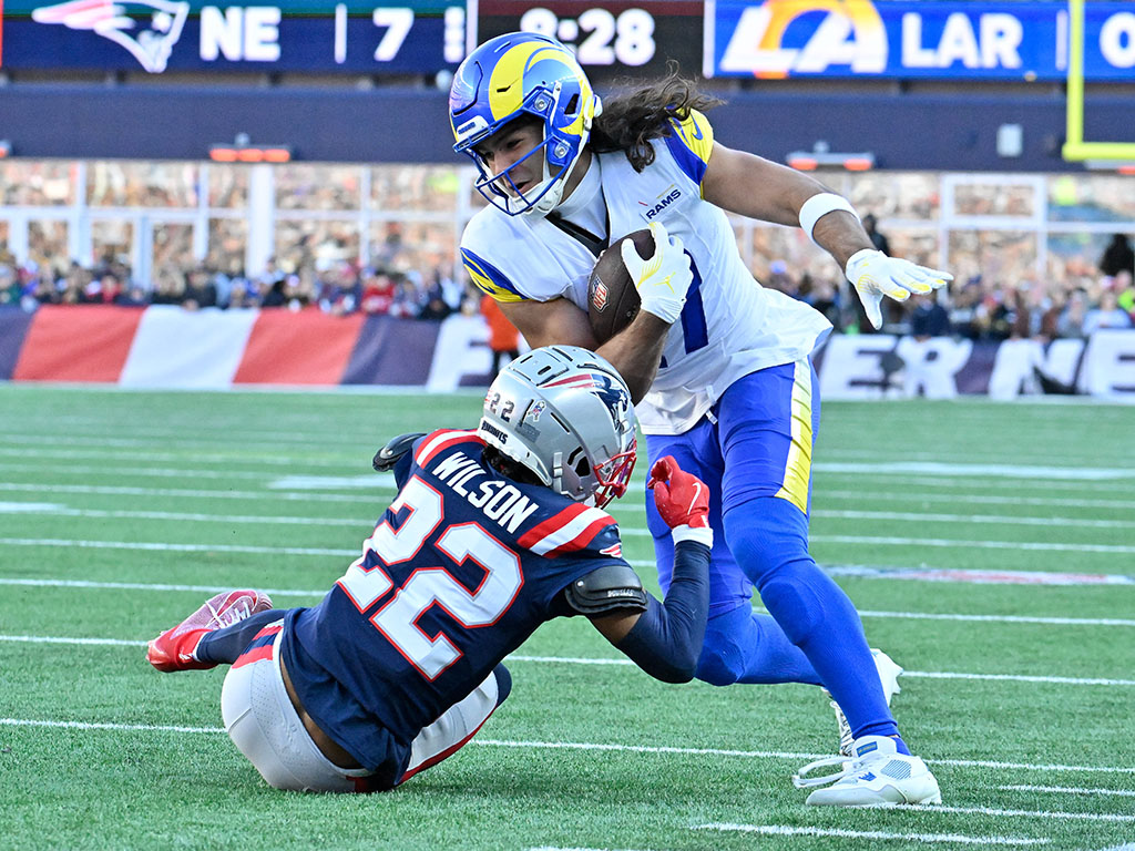 Nov 17, 2024; Foxborough, Massachusetts, USA; New England Patriots cornerback Marco Wilson (22) tries to tackle Los Angeles Rams wide receiver Puka Nacua (17) during the first half at Gillette Stadium. Mandatory Credit: Eric Canha-Imagn Images