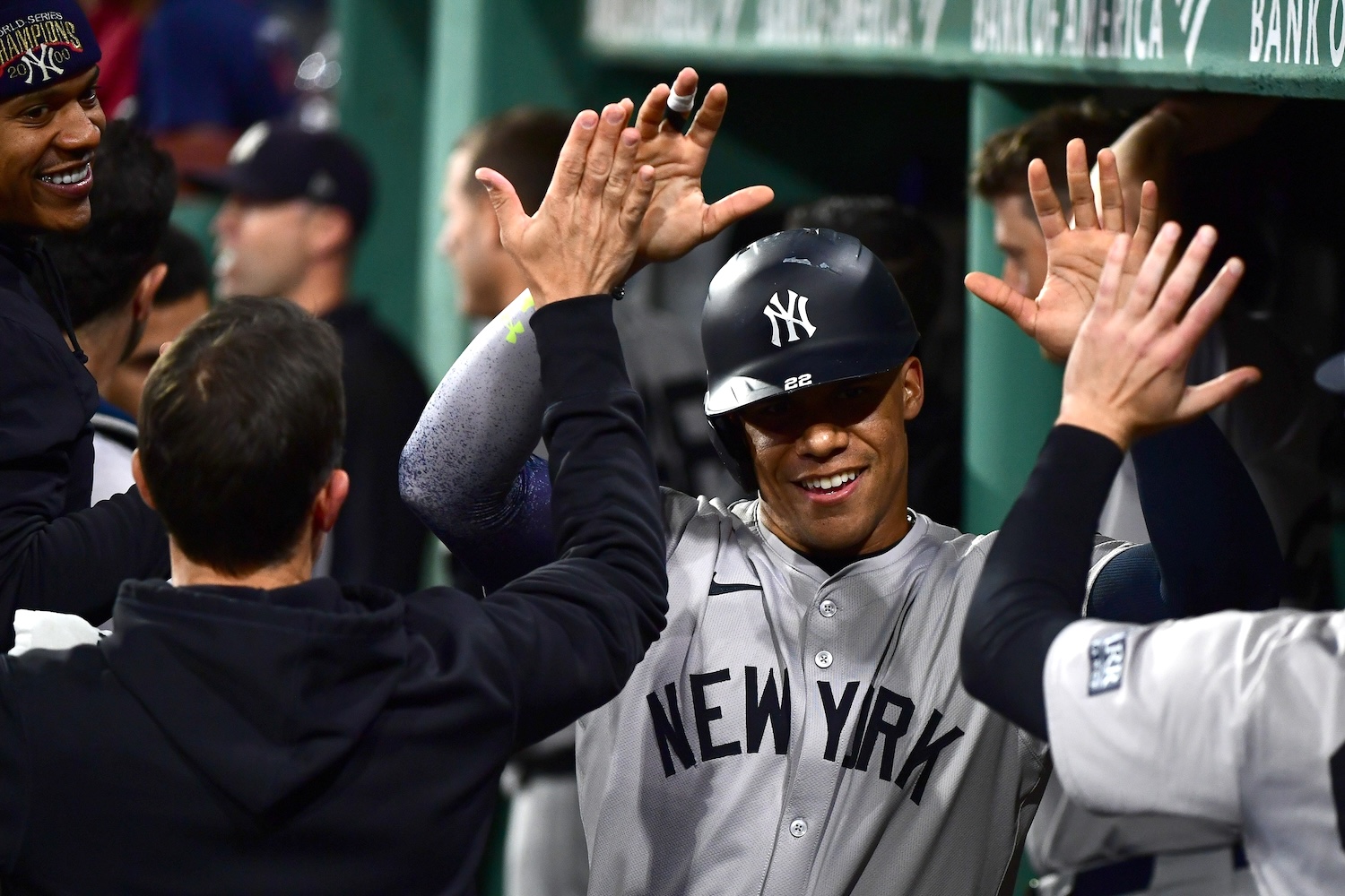 Jun 15, 2024; Boston, Massachusetts, USA; New York Yankees left fielder Juan Soto (22) is greeted in the dugout after hitting a home run during the seventh inning against the Boston Red Sox at Fenway Park. Mandatory Credit: Bob DeChiara-USA TODAY Sports