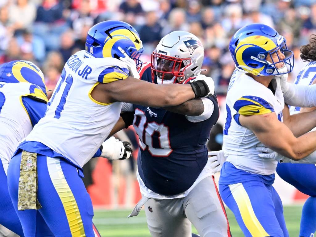 Nov 17, 2024; Foxborough, Massachusetts, USA;  New England Patriots defensive tackle Christian Barmore (90) blocks Los Angeles Rams offensive tackle Warren McClendon Jr. (71) during the first half at Gillette Stadium. Mandatory Credit: Eric Canha-Imagn Images