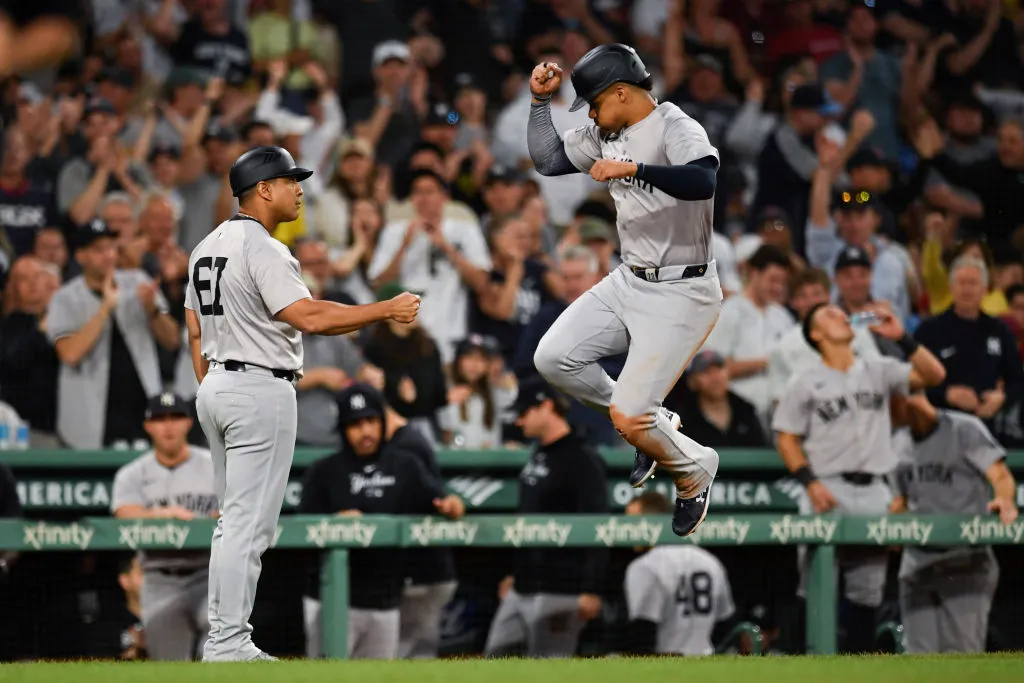 BOSTON, MASSACHUSETTS - JUNE 15: Third base coach Luis Rojas #67 of the New York Yankees, left, celebrates with Juan Soto #22 of the New York Yankees after Soto hits a one-run home run during the seventh inning of a game against the Boston Red Sox at Fenway Park on June 15, 2024 in Boston, Massachusetts. (Photo by Jaiden Tripi/Getty Images)