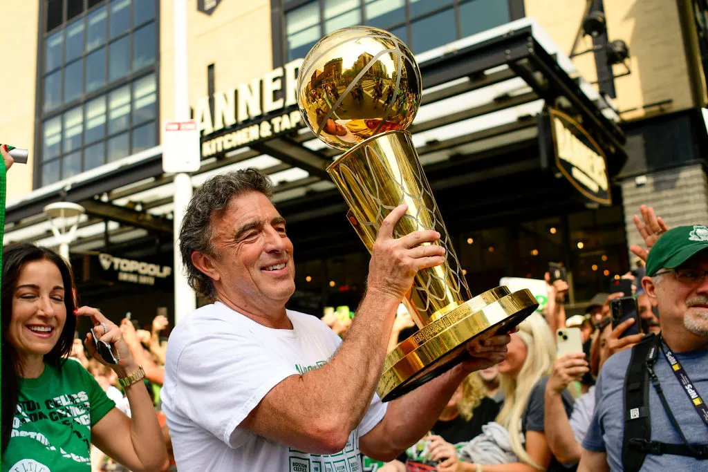 BOSTON, MASSACHUSETTS - JUNE 21: Owner Wyc Grousbeck of the Boston Celtics reacts as he holds the Larry O'Brien Championship Trophy during the 2024 Boston Celtics championship parade following their 2024 NBA Finals win on June 21, 2024 in Boston, Massachusetts. (Photo by Billie Weiss/Getty Images)