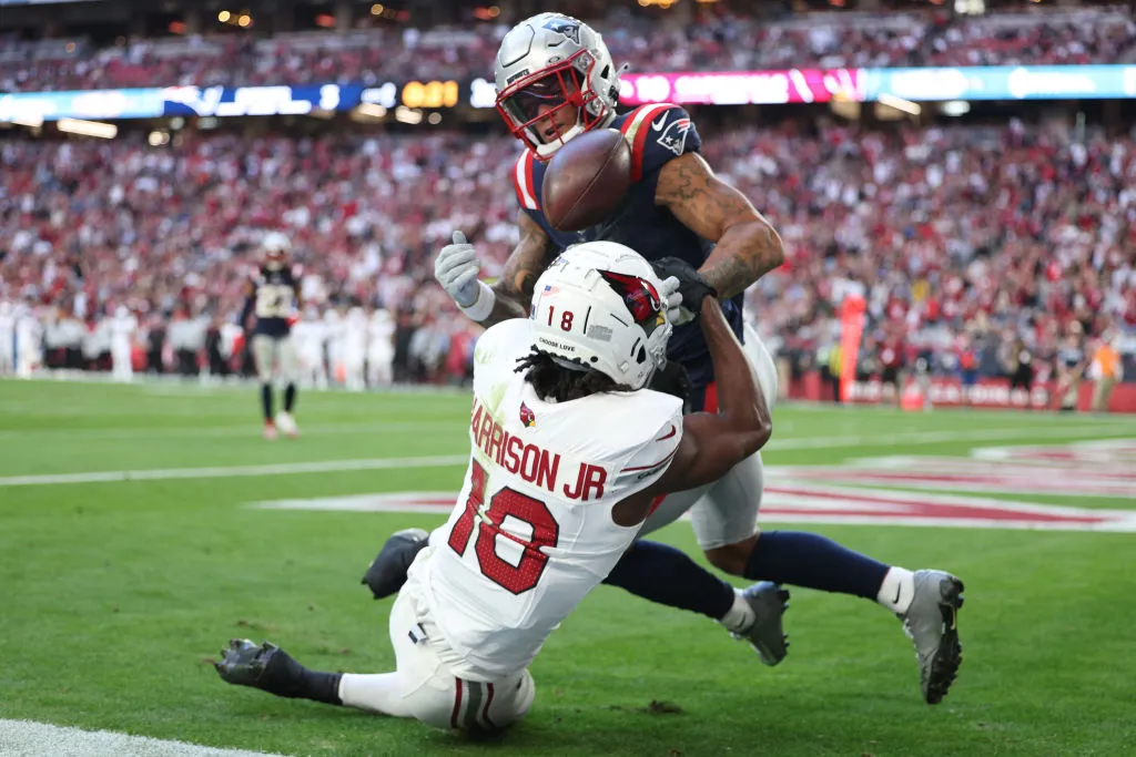 GLENDALE, ARIZONA - DECEMBER 15: Christian Gonzalez #0 of the New England Patriots breaks up a catch by Marvin Harrison Jr. #18 of the Arizona Cardinals in the second quarter of the game at State Farm Stadium on December 15, 2024 in Glendale, Arizona. (Photo by Mike Christy/Getty Images)