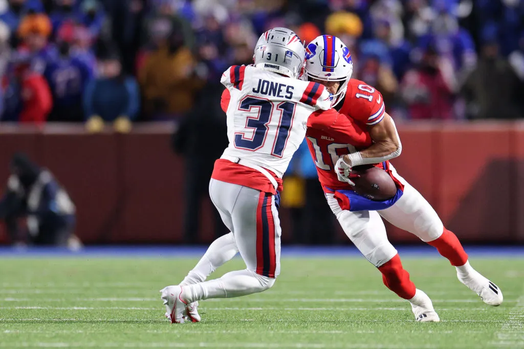 ORCHARD PARK, NEW YORK - DECEMBER 22: Jonathan Jones #31 of the New England Patriots punches the ball against Khalil Shakir #10 of the Buffalo Bills during the fourth quarter at Highmark Stadium on December 22, 2024 in Orchard Park, New York. (Photo by Bryan M. Bennett/Getty Images)