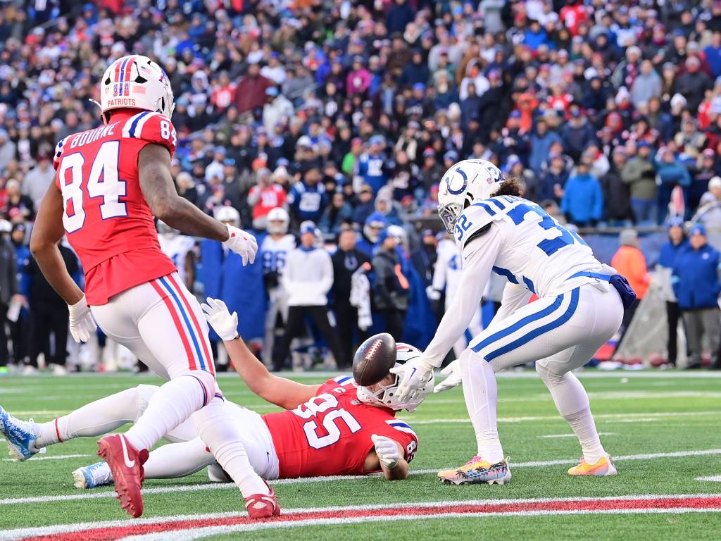 Dec 1, 2024; Foxborough, Massachusetts, USA; New England Patriots tight end Hunter Henry (85) fumbles the ball at the goal line into Indianapolis Colts safety Julian Blackmon (32) during the second half at Gillette Stadium. Photo Credit: Eric Canha-Imagn Images