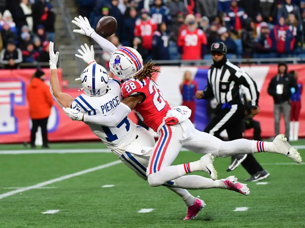 Dec 1, 2024; Foxborough, Massachusetts, USA; New England Patriots cornerback Alex Austin (28) breaks up a pass intended for Indianapolis Colts wide receiver Alec Pierce (14) during the second half at Gillette Stadium. Photo Credit: Bob DeChiara-Imagn Images