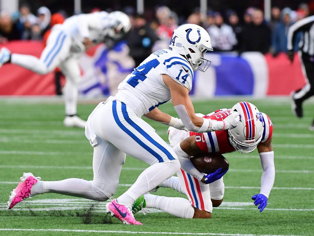 Dec 1, 2024; Foxborough, Massachusetts, USA; New England Patriots cornerback Christian Gonzalez (0) intercepts a pass intended for Indianapolis Colts wide receiver Alec Pierce (14) during the second half at Gillette Stadium. Photo Credit: Bob DeChiara-Imagn Images