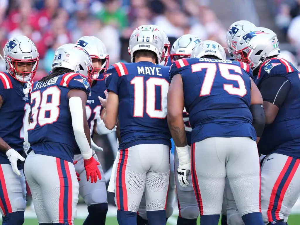 Dec 15, 2024; Glendale, Arizona, USA; New England Patriots quarterback Drake Maye (10) huddles teammates against the Arizona Cardinals during the first half at State Farm Stadium. Credit: Joe Camporeale-Imagn Images