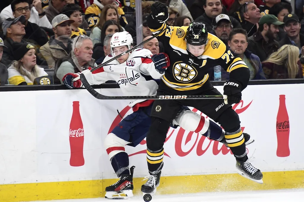 Dec 23, 2024; Boston, Massachusetts, USA; Boston Bruins defenseman Charlie McAvoy (73) checks Washington Capitals left wing Andrew Mangiapane (88) during the second period at TD Garden. Mandatory Credit: Bob DeChiara-Imagn Images