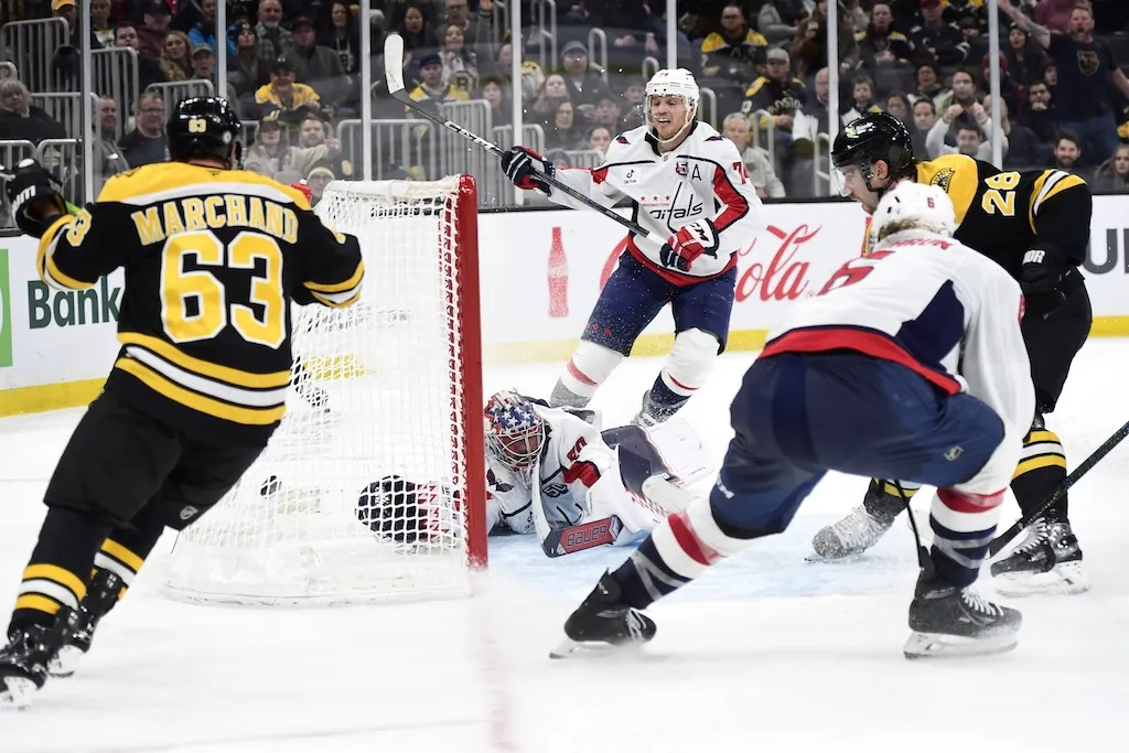 Dec 23, 2024; Boston, Massachusetts, USA; Boston Bruins center Elias Lindholm (28) tucks the puck past Washington Capitals goaltender Charlie Lindgren (79) during the third period at TD Garden. Mandatory Credit: Bob DeChiara-Imagn Images